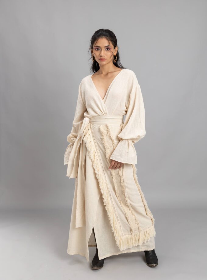 Overlapping dress with an wrap around skirt embellished with fringes