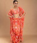 Coral printed drape skirt with embroidered choli and a cape