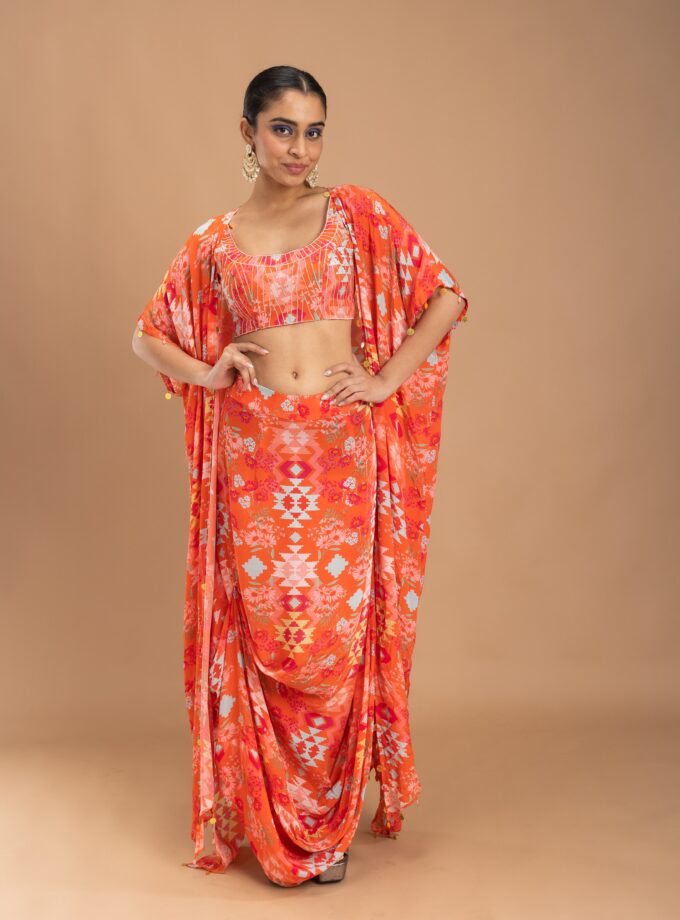 Coral printed drape skirt with embroidered choli and a cape