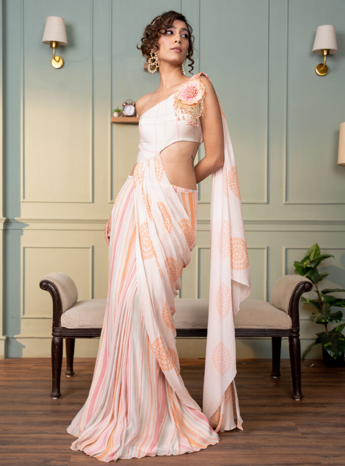 Ivory one shoulder drape saree with hand  embroidered motif