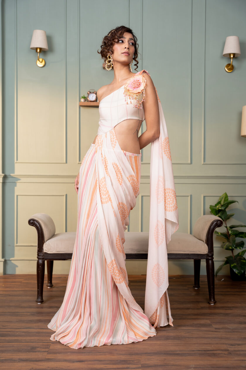 Ivory one shoulder drape saree with hand  embroidered motif