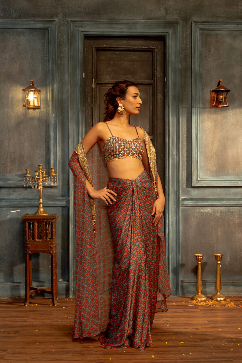 Teal checks printed silk draped skirt with  embroidered choli and cape