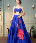 Electric blue raw silk lehenga with motive and hand  embroidered choli