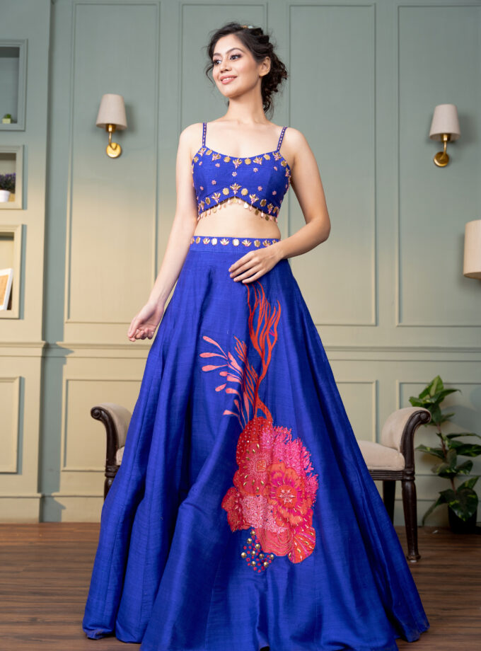 Electric blue raw silk lehenga with motive and hand  embroidered choli