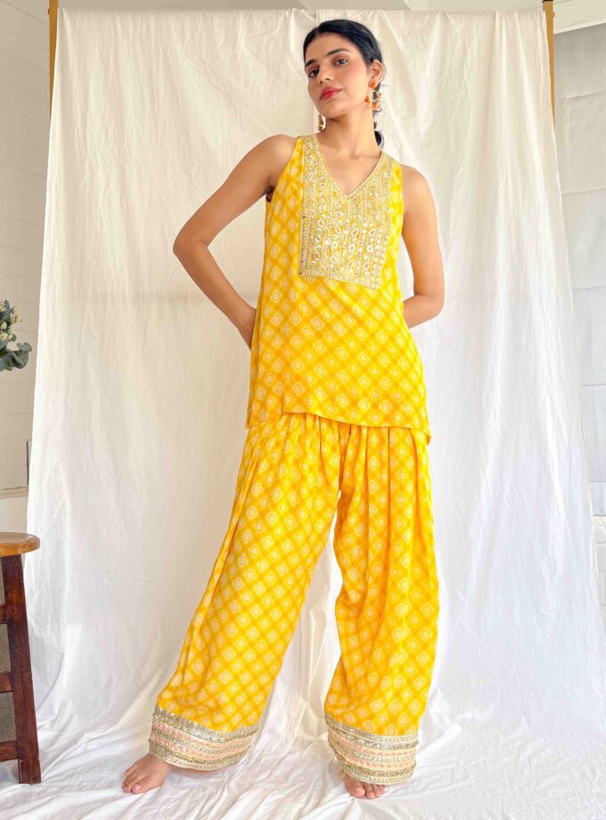 Yellow printed silk kurta with mirror work yoke and Farshi salwar